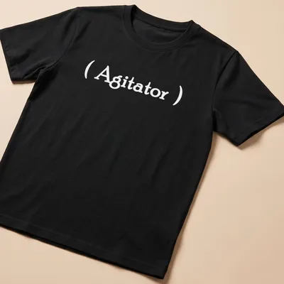 Minimalist Agitator t-shirt with bold white lettering on a simple background