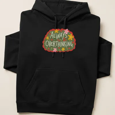 Whimsical floral design with the text 'Always OVERTHINKING' in vibrant colors on green. — printed on a unisex hoodie