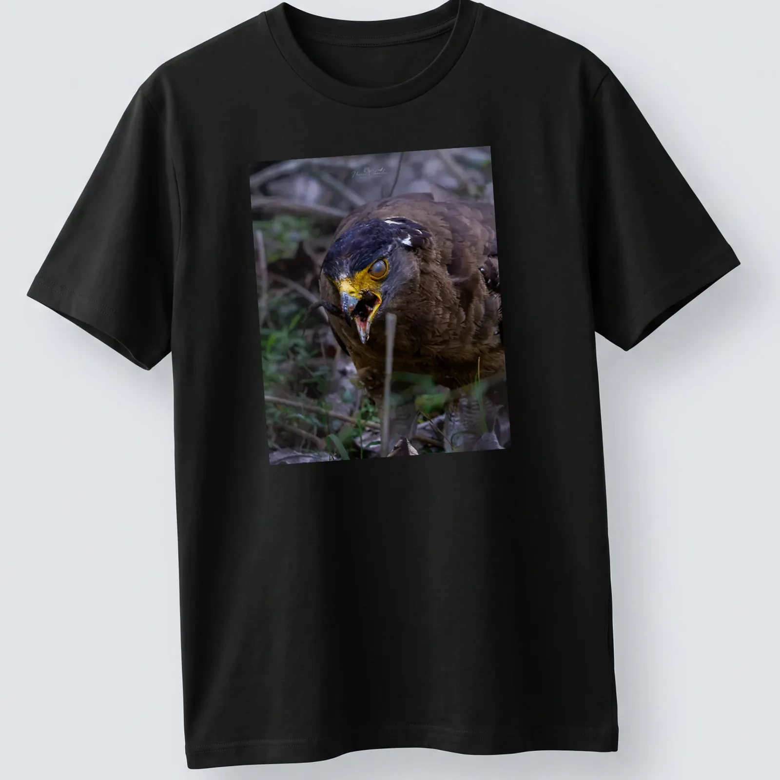 Realistic photo of an angry bird with yellow beak and dark feathers — printed on a unisex t-shirt