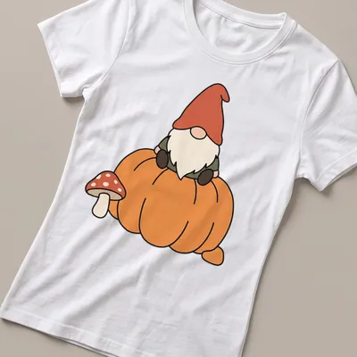 Kawaii gnome sitting on a pumpkin with a mushroom, featuring autumn colors — printed on a women's shirt