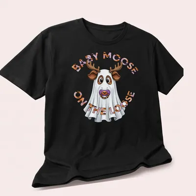 Cartoon baby moose in a ghost costume with Halloween-themed text above. — printed on a unisex t-shirt (angled view)