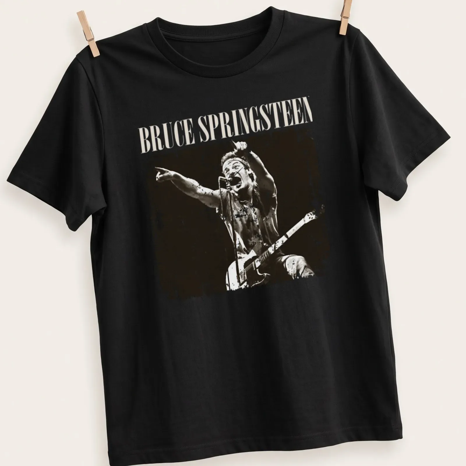 Vintage distressed t-shirt featuring Bruce Springsteen in black and cream typography — printed on a unisex t-shirt