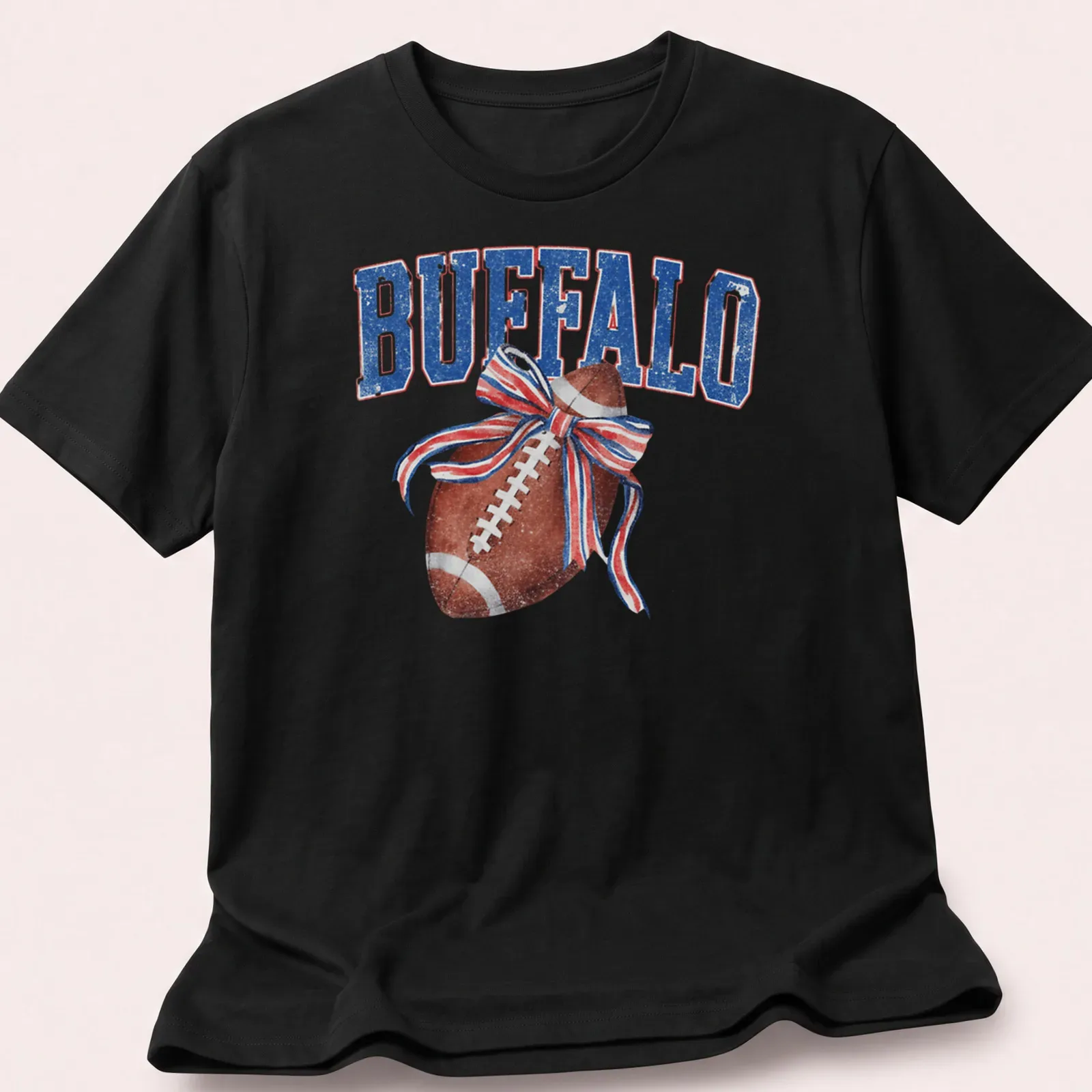 Vintage distressed t-shirt featuring a football with a bow and the text BUFFALO — printed on a unisex t-shirt