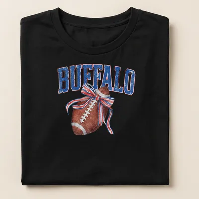 Vintage distressed t-shirt featuring a football with a bow and the text BUFFALO — printed on a women's shirt