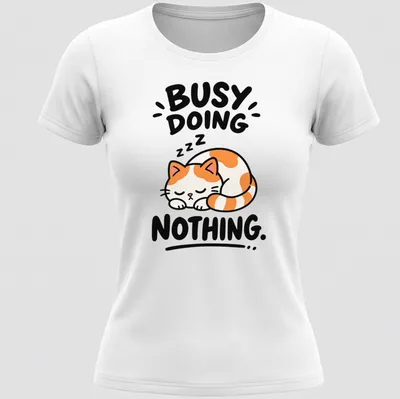 Kawaii line-art of a calico cat with text 'BUSY DOING NOTHING' in orange, white, black — printed on a women's shirt