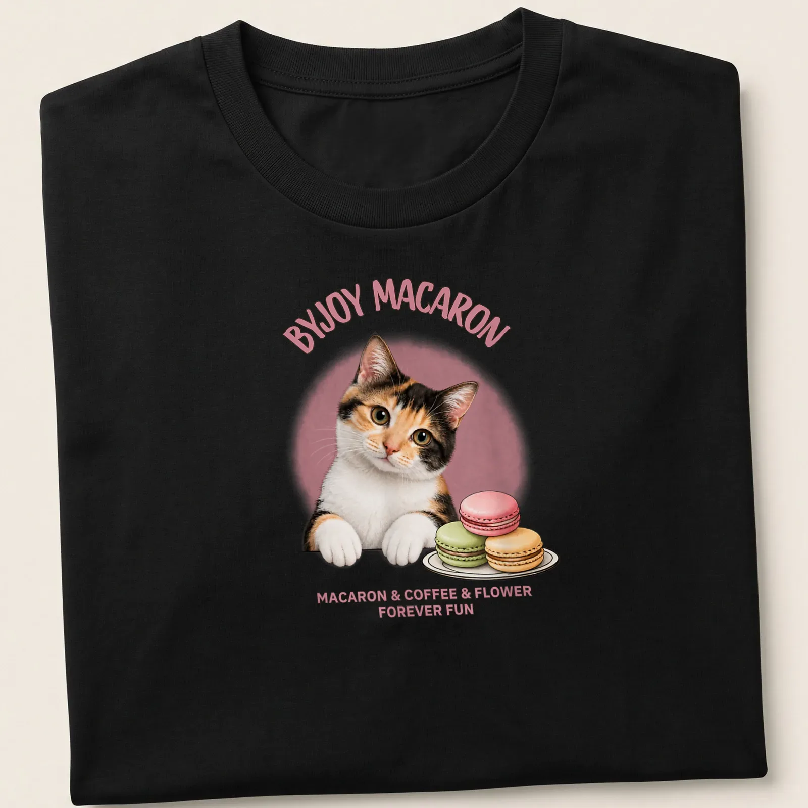 Cute calico cat surrounded by macarons and flowers with playful text — printed on a unisex t-shirt