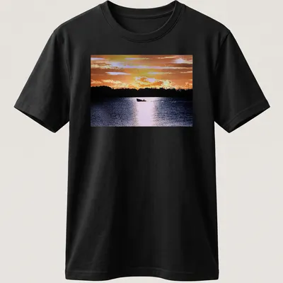 Boat silhouette against a colorful sunset in orange, yellow, and blue