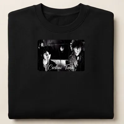 Black and white design featuring Cocteau Twins band name and photography — printed on a unisex sweatshirt