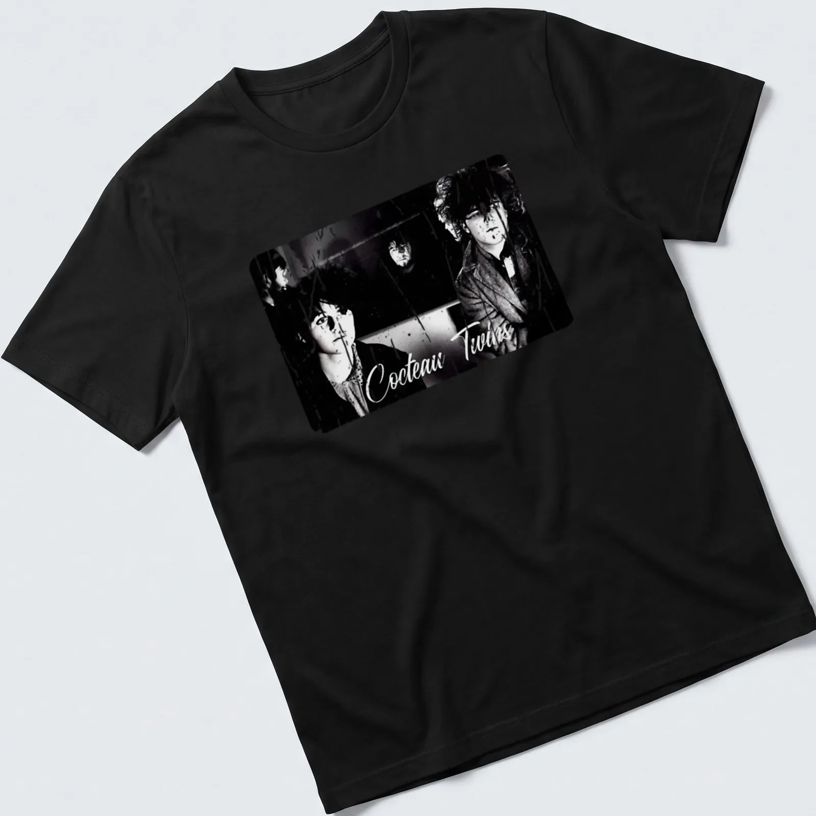 Black and white design featuring Cocteau Twins band name and photography — printed on a unisex t-shirt