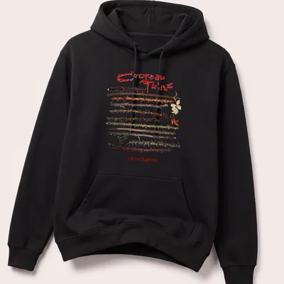 Vintage Cocteau Twins t-shirt featuring thorns around the text in earthy colors — printed on a unisex hoodie