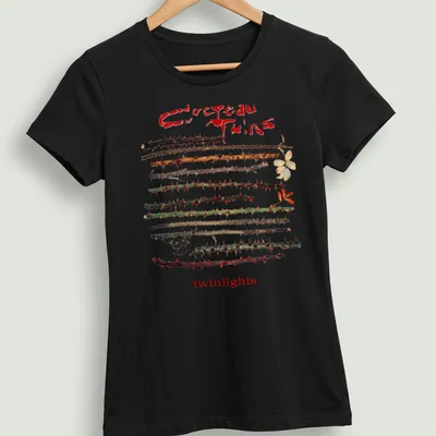 Vintage Cocteau Twins t-shirt featuring thorns around the text in earthy colors — printed on a women's shirt
