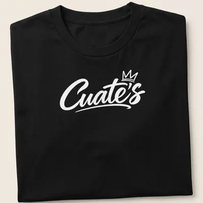 White script font reading 'Cuate's' on a barbershop themed shirt