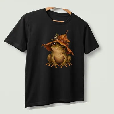 Realistic frog wearing a leaf hat with green and brown colors — printed on a unisex t-shirt (angled view)