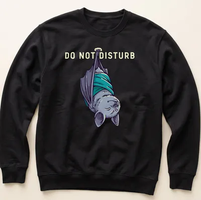 Cartoonish sleeping bat graphic with 'DO NOT DISTURB' text above in gray and teal — printed on a unisex sweatshirt