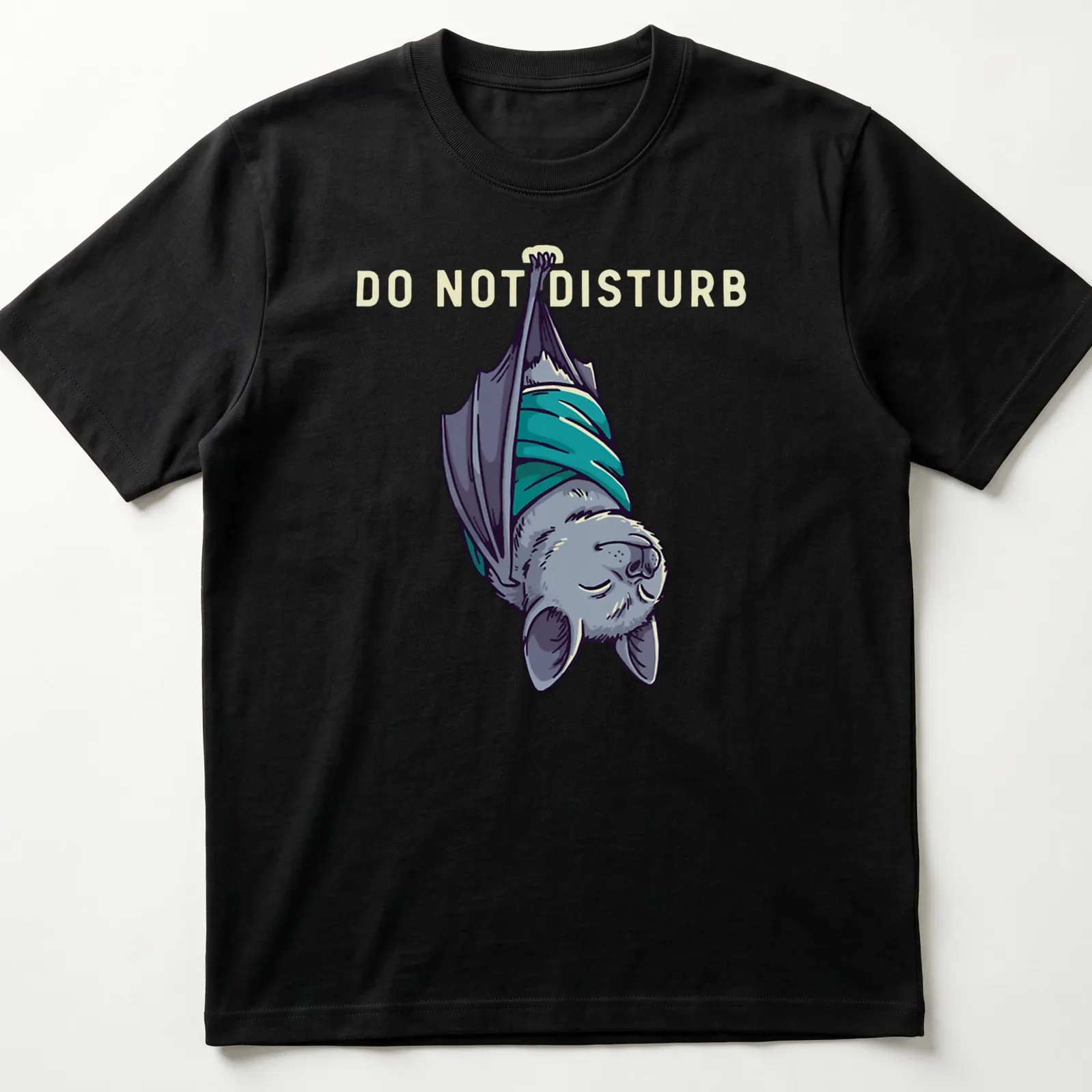 Cartoonish sleeping bat graphic with 'DO NOT DISTURB' text above in gray and teal — printed on a unisex t-shirt
