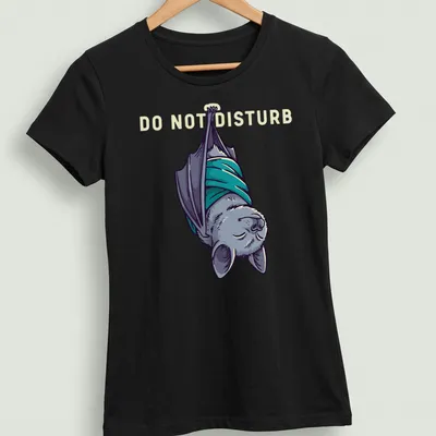 Cartoonish sleeping bat graphic with 'DO NOT DISTURB' text above in gray and teal — printed on a women's shirt