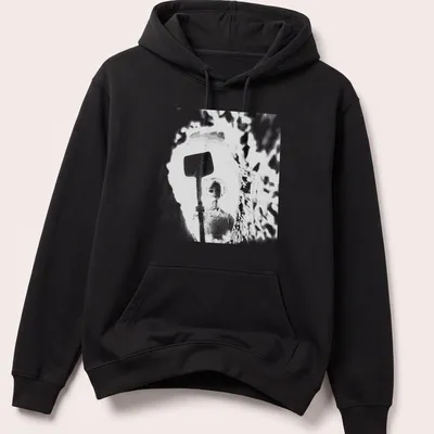 Distressed t-shirt featuring a doll holding a shovel in black, white, and gray — printed on a unisex hoodie