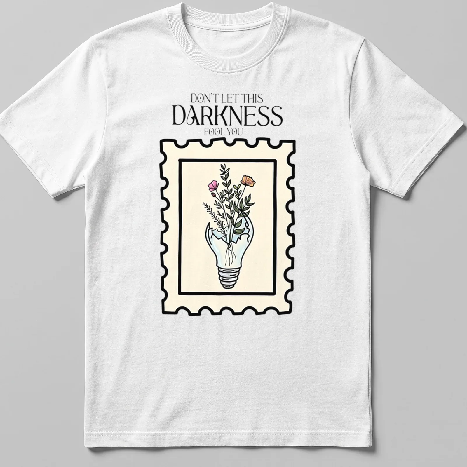 Illustrative design of a light bulb with flowers and text in pastel colors — printed on a unisex t-shirt