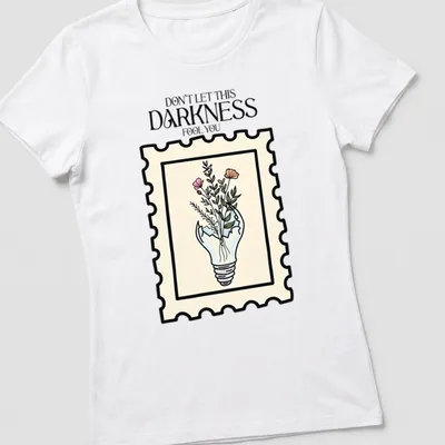 Illustrative design of a light bulb with flowers and text in pastel colors — printed on a women's shirt