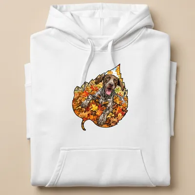 Realistic print of a German Shorthaired Pointer playing in colorful autumn leaves — printed on a unisex hoodie