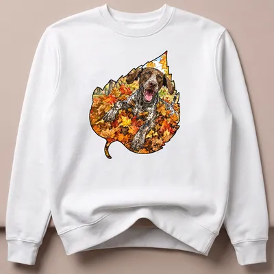 Realistic print of a German Shorthaired Pointer playing in colorful autumn leaves — printed on a unisex sweatshirt