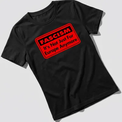 Bold typography shirt featuring text about fascism in red and black — printed on a women's shirt