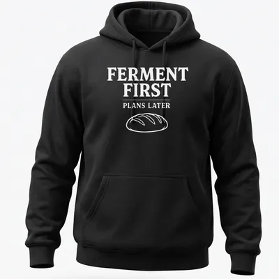 Bold typographic design shirt stating 'FERMENT FIRST PLANS LATER' with sourdough bread imagery — printed on a unisex hoodie