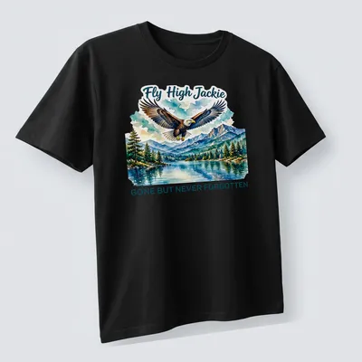 Watercolor print of a bald eagle with the text 'Fly High Jackie GONE BUT NEVER FORGOTTEN' — printed on a unisex t-shirt (angled view)