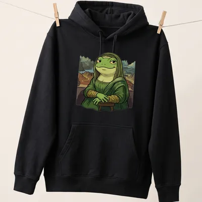 Cartoon graphic of a frog styled as the Mona Lisa with playful lettering — printed on a unisex hoodie