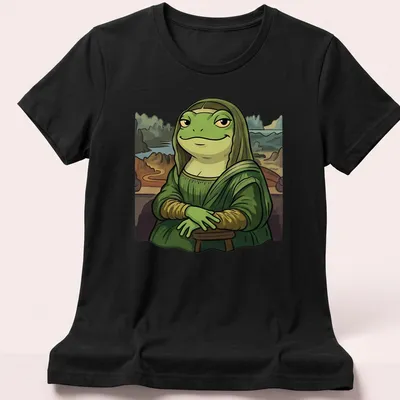 Cartoon graphic of a frog styled as the Mona Lisa with playful lettering — printed on a women's shirt