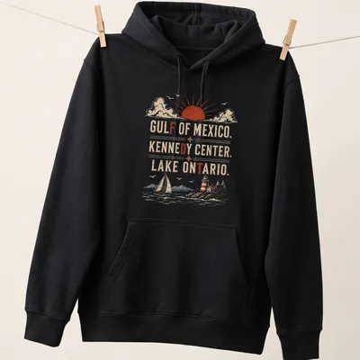 Vintage retro T-shirt with sailboat, lighthouse, and mountains at sunset — printed on a unisex hoodie