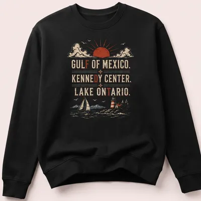 Vintage retro T-shirt with sailboat, lighthouse, and mountains at sunset — printed on a unisex sweatshirt