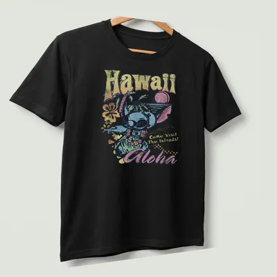 Vintage tropical shirt featuring an alien in holiday attire and vibrant colors — printed on a unisex t-shirt (angled view)