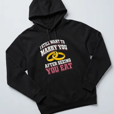 Bold text and wedding rings on a playful t-shirt about love and food — printed on a unisex hoodie
