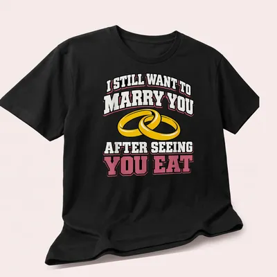 Bold text and wedding rings on a playful t-shirt about love and food — printed on a unisex t-shirt (angled view)