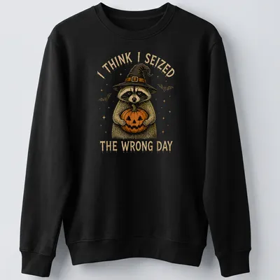 Vintage illustration of a raccoon holding a pumpkin with humorous text — printed on a unisex sweatshirt