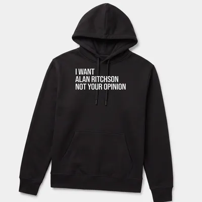 Bold text on a black and white tee expressing a humorous preference for Alan Ritchson. — printed on a unisex hoodie