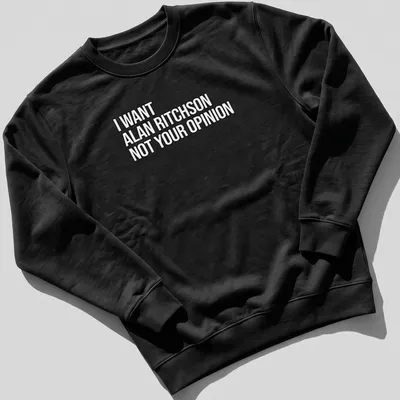 Bold text on a black and white tee expressing a humorous preference for Alan Ritchson. — printed on a unisex sweatshirt