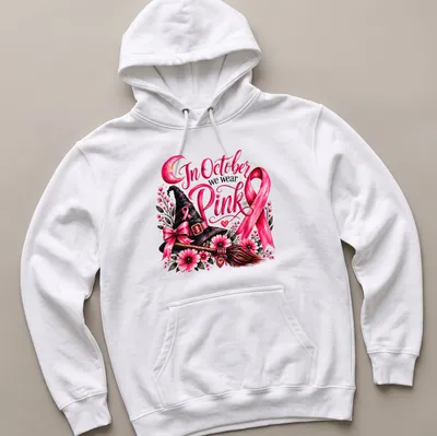 Vintage floral design of a pink witch hat and broom with the text In October we wear Pink — printed on a unisex hoodie