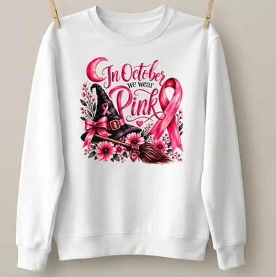 Vintage floral design of a pink witch hat and broom with the text In October we wear Pink — printed on a unisex sweatshirt