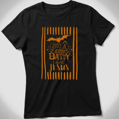 Playful T-shirt featuring a bat and the text 'Just A Little Batty About Jesus' in orange and white — printed on a women's shirt