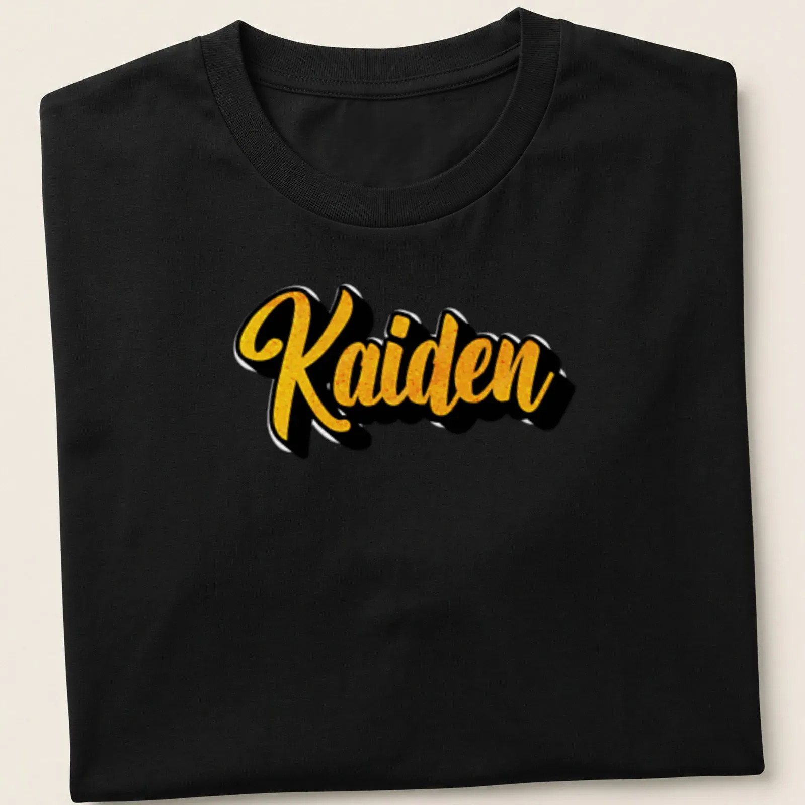 Personalized T-shirt with the name Kaiden in bold gold script on black — printed on a unisex t-shirt