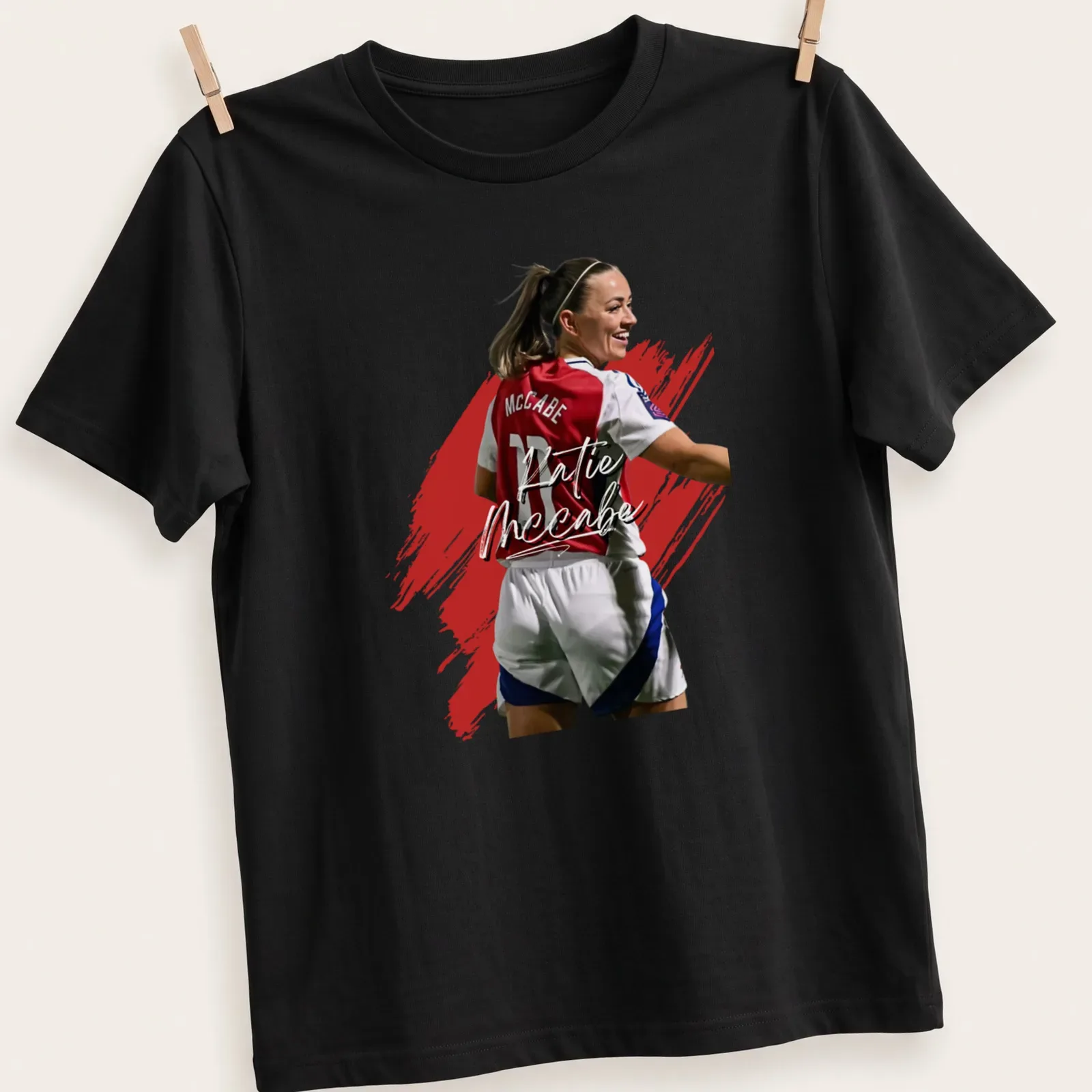 Painted effect t-shirt featuring soccer player Katie McCabe in red, white, and blue — printed on a unisex t-shirt