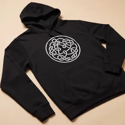 Intricate Celtic knot design in white line art on a — printed on a unisex hoodie