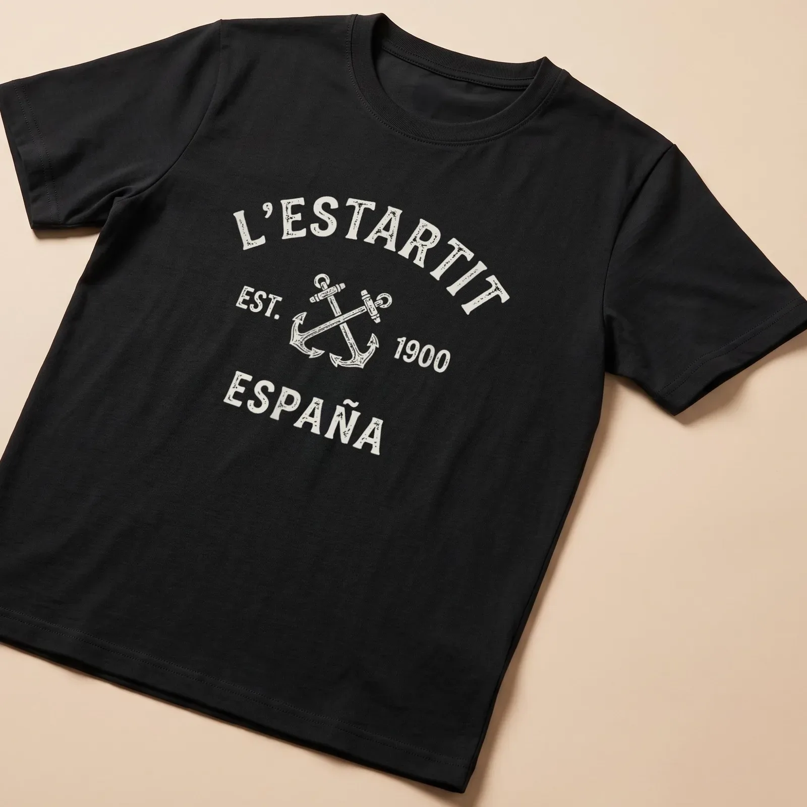 Vintage print featuring crossed anchors and town name on a cream — printed on a unisex t-shirt