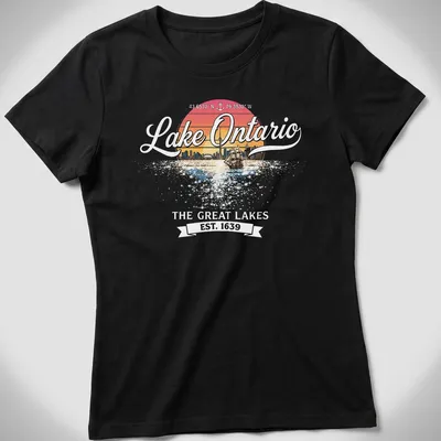 Retro sunset T-shirt featuring a sailboat and city skyline around Lake Ontario — printed on a women's shirt