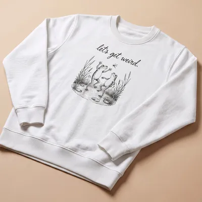 Vintage illustrated frogs dancing under the text 'let's get weird.' in playful font — printed on a unisex sweatshirt