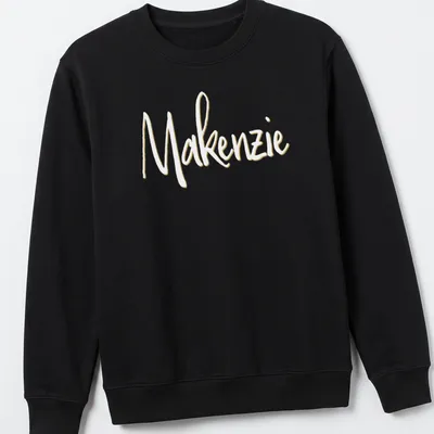 Personalized shirt featuring the name Makenzie in elegant gold script. — printed on a unisex sweatshirt