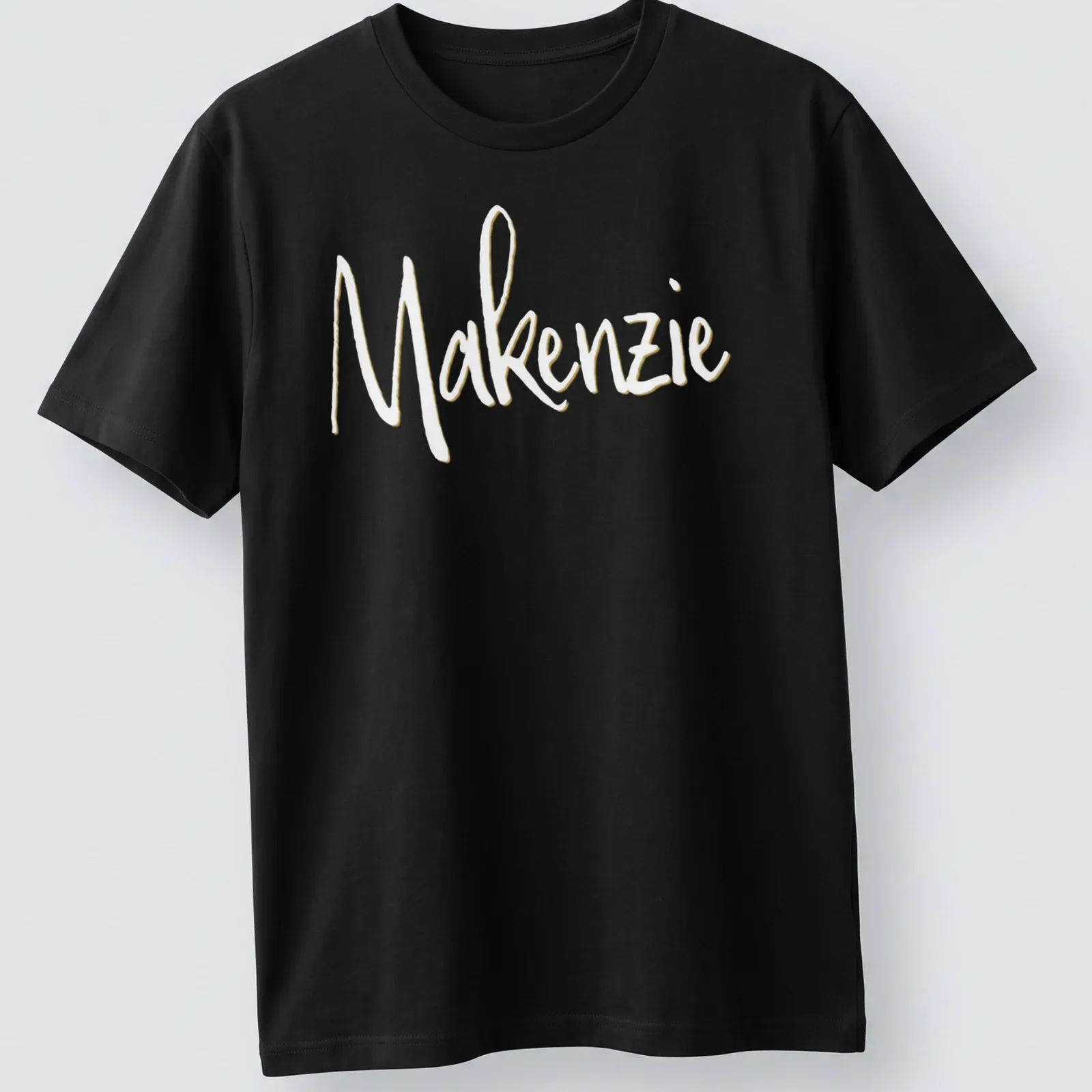 Personalized shirt featuring the name Makenzie in elegant gold script. — printed on a unisex t-shirt