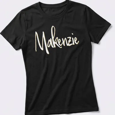 Personalized shirt featuring the name Makenzie in elegant gold script. — printed on a women's shirt